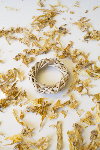 Wicker ring with dried yellow flowers on a white background