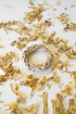 Wicker ring with dried yellow flowers on a white background